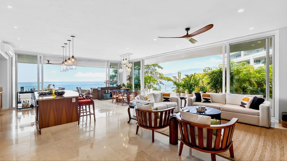 Open-plan living room with sliding walls open to the ocean