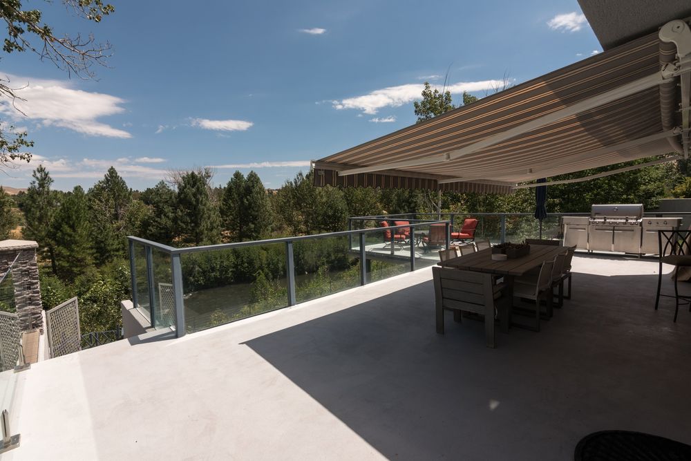 Covered upper deck with outdoor dining and gas grill