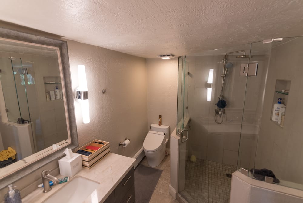 Bathroom with glass walk-in shower and vanity